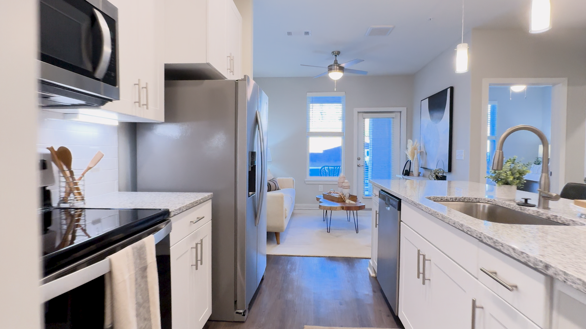 Kitchen of the POINTE 1B/1B apartment home, looking into the living space.