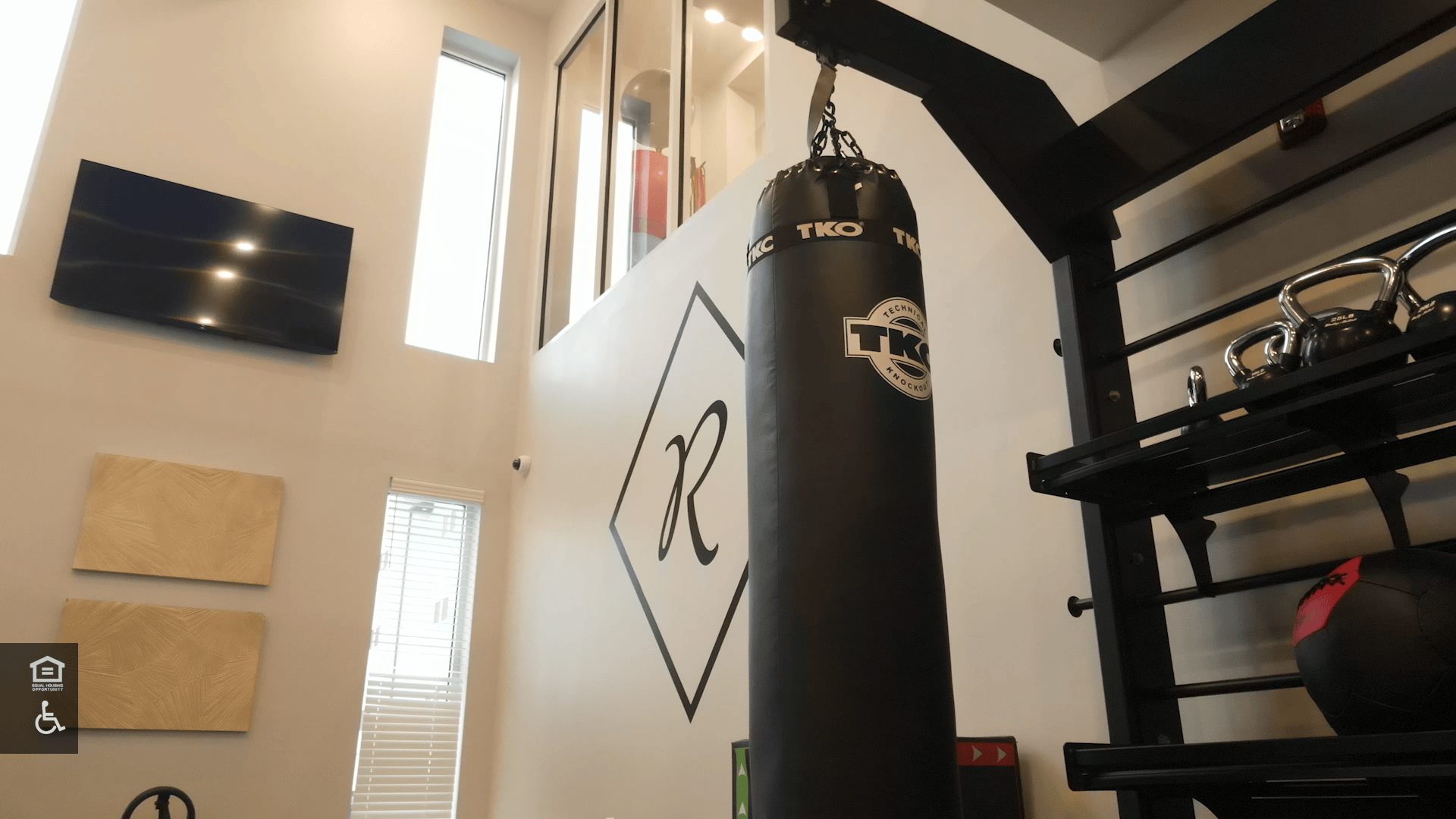 Heavy Punching Bag hangs in front of the Ravelle Icon in the 2-story fitness center.