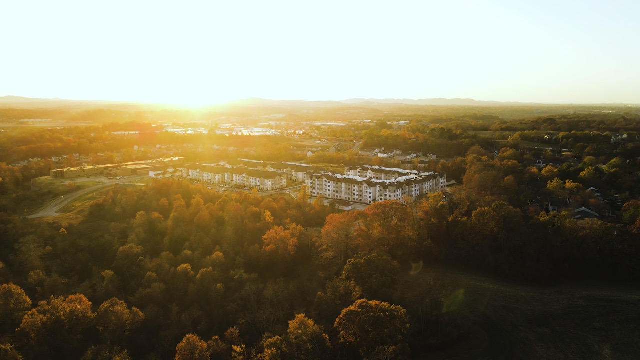 Aerial view of The Ravelle at Ridgeview apartment community in Southeast Nashville. The sun is setting behind the Tennessee hills. Aerial view of The Ravelle at Ridgeview apartment community in Southeast Nashville. The sun is setting behind the Tennessee hills.