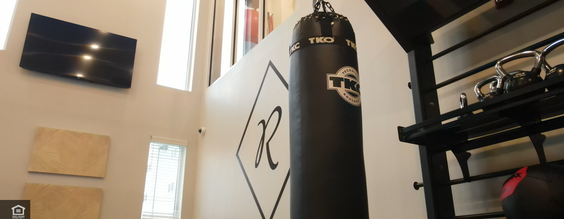 Heavy Punching Bag hangs in front of the Ravelle Icon in the 2-story fitness center.