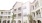 View form courtyard, looking up at balconies of residential building.