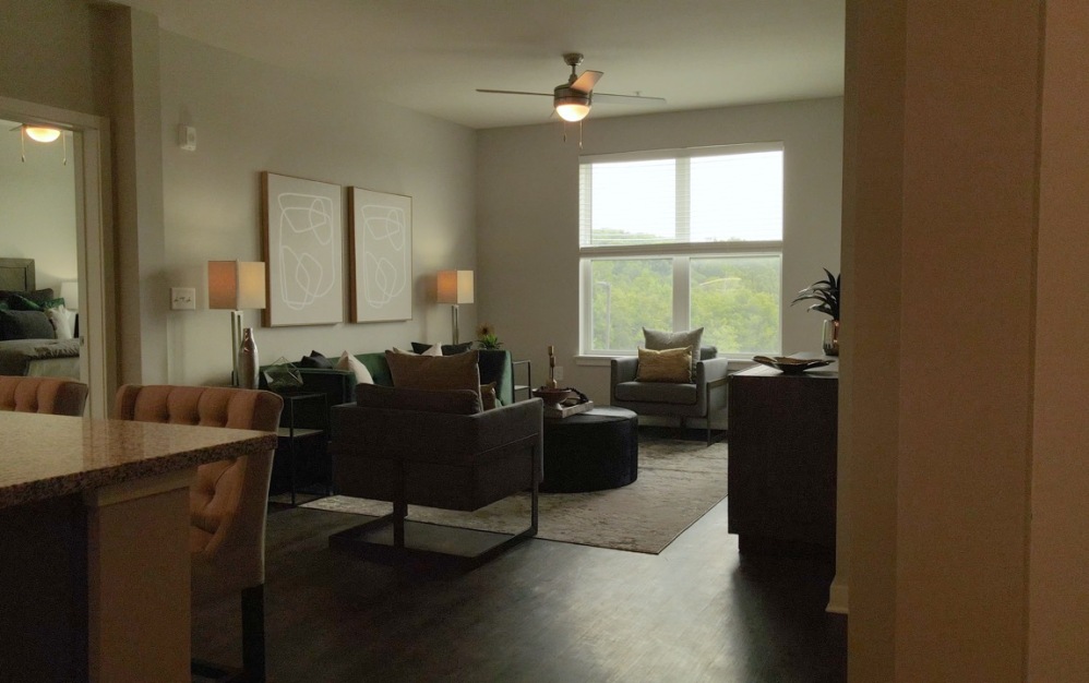 Open-concept layout in the Vista floor plan at The Ravelle in Nashville, Tennessee showing living space, dining area, and access to bedrooms