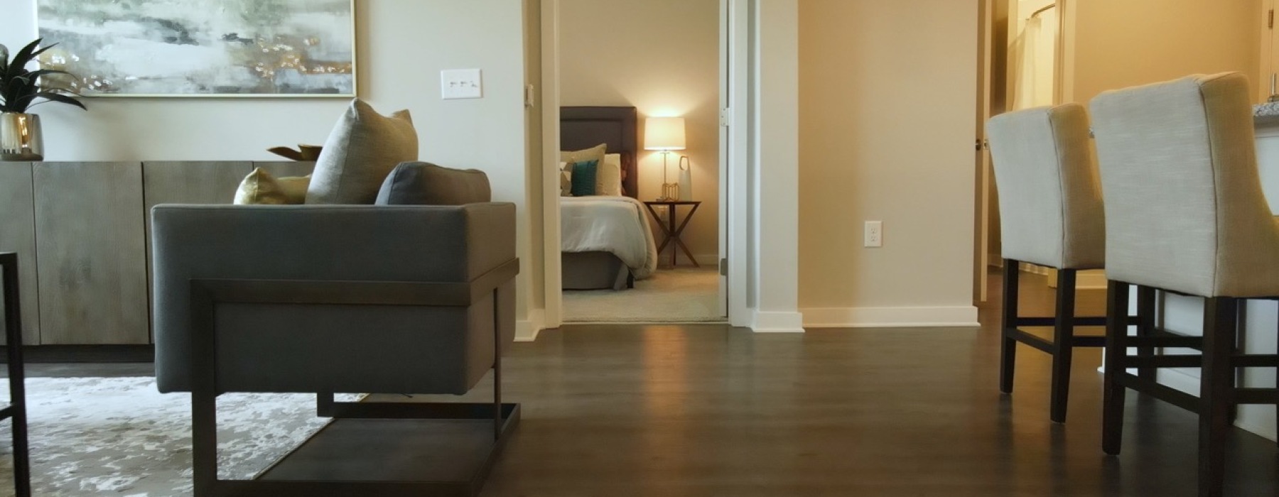 Bedroom in the Vista two-bedroom, two-bath apartment home at The Ravelle in Nashville, shown from the hallway with natural light from large window