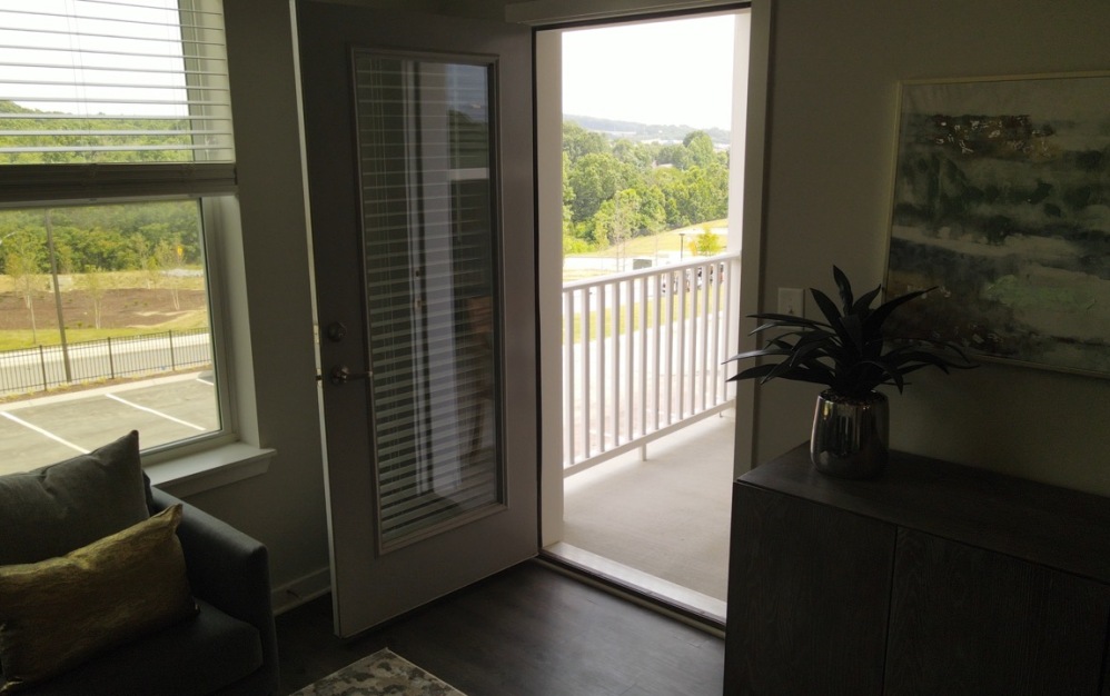 Vista two-bedroom apartment home at The Ravelle in Nashville featuring private balcony access and large windows with scenic views